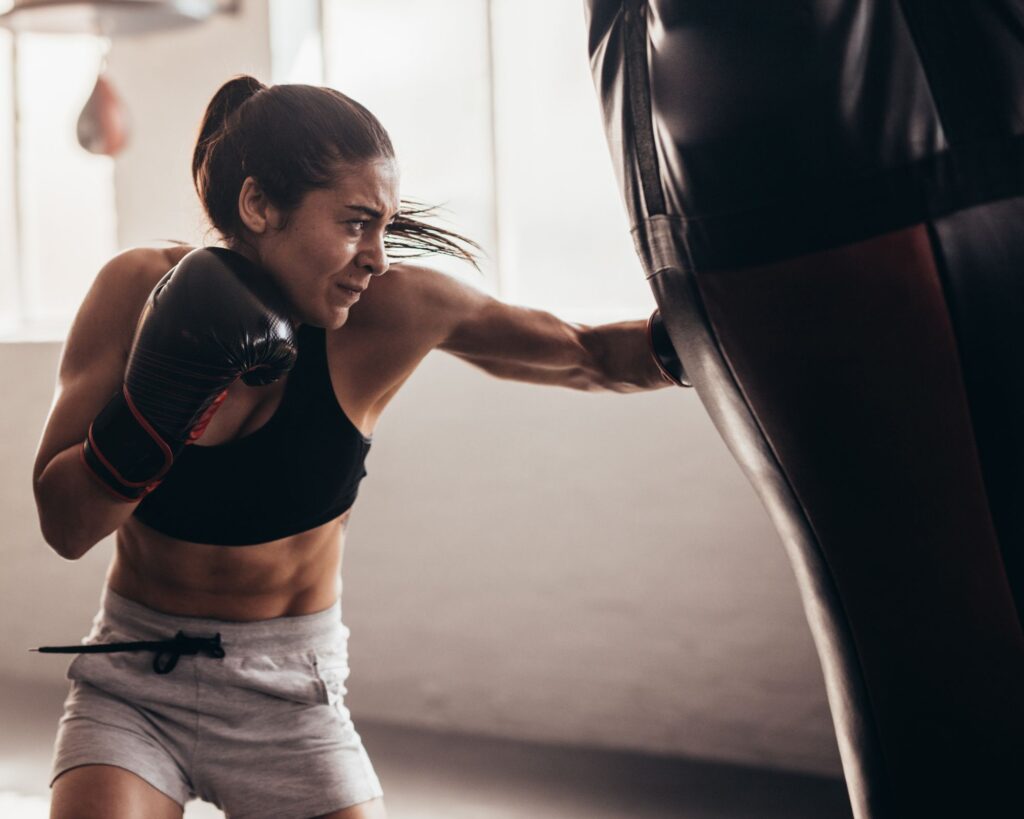 キックボクサーがパンチを打つ様子｜上腕二頭筋腱に負担がかかる動作イメージ